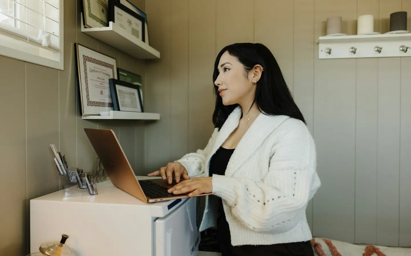 A business owner working on a laptop in her office